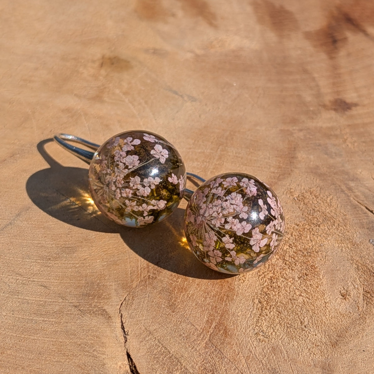 Handmade white flower moss resin ball earrings on wooden surface, 3.5cm botanical jewelry EL Creations