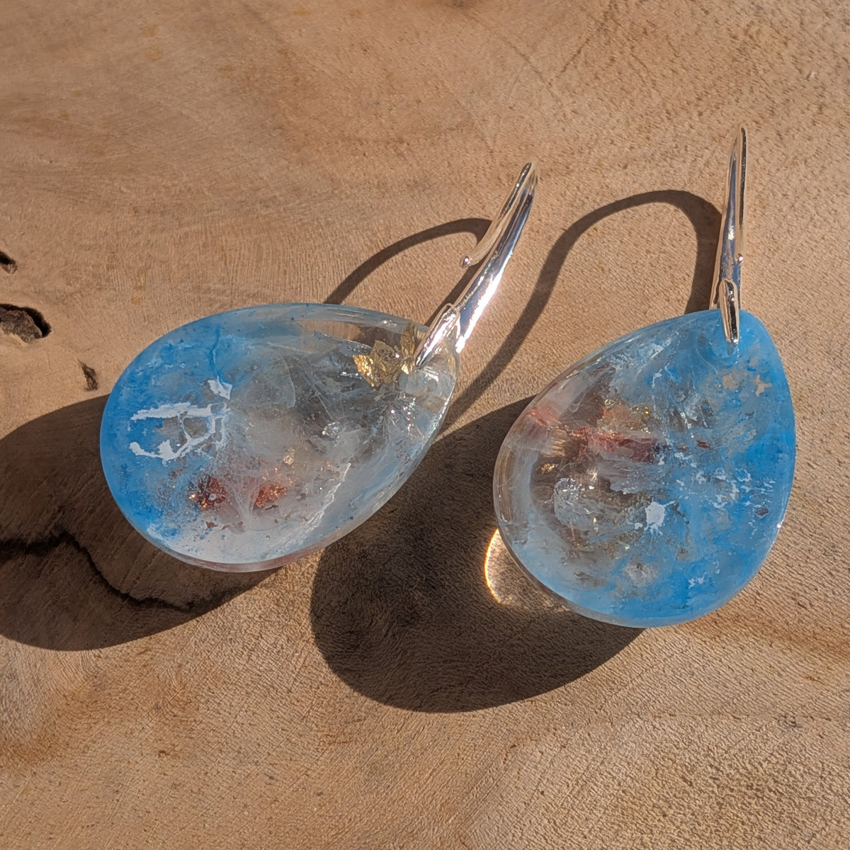 Reverse view of blue and white resin teardrop earrings with silver hooks, EL-Creations