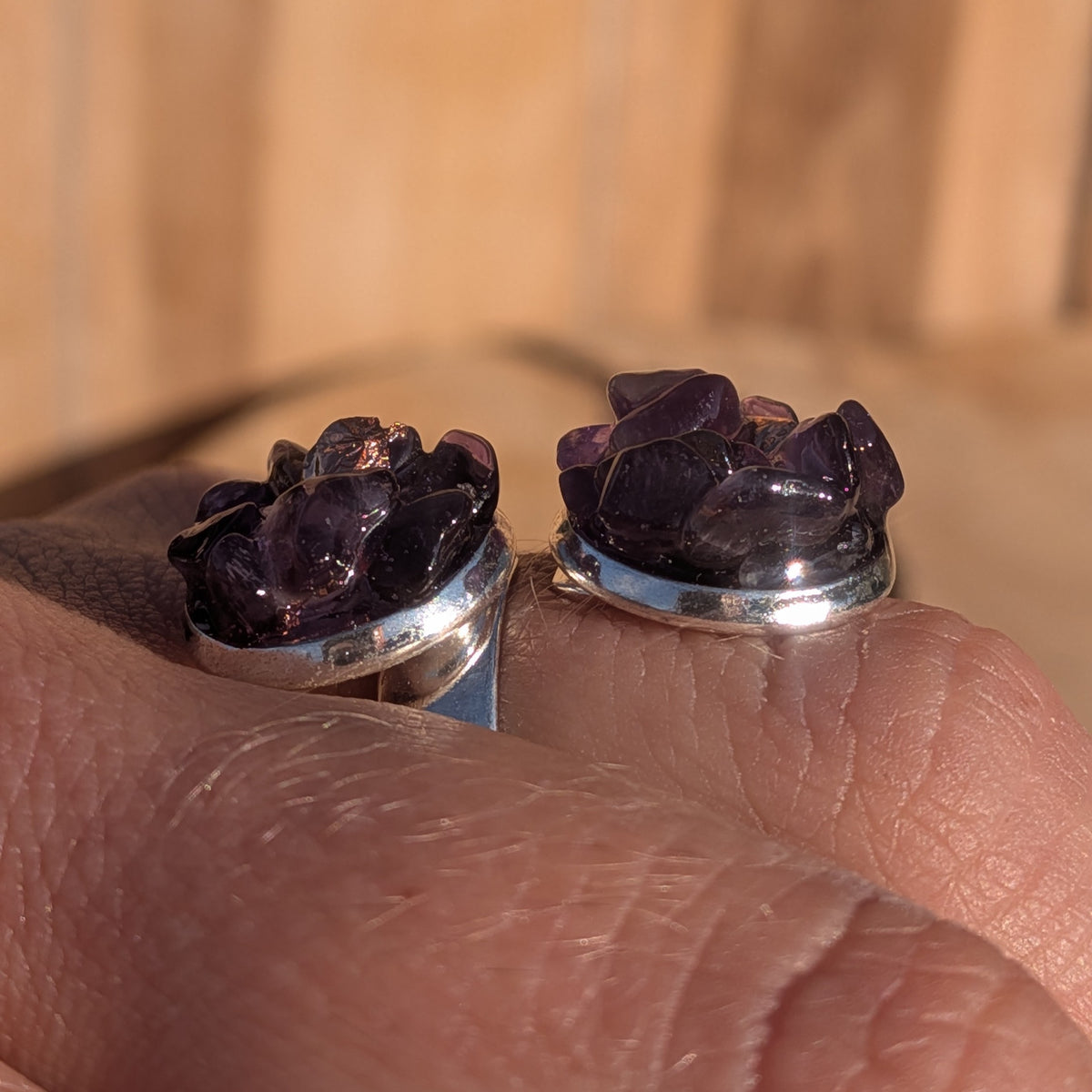 Low side view of the amethyst ring showing raised stone details above both settings, EL-Creations⠋