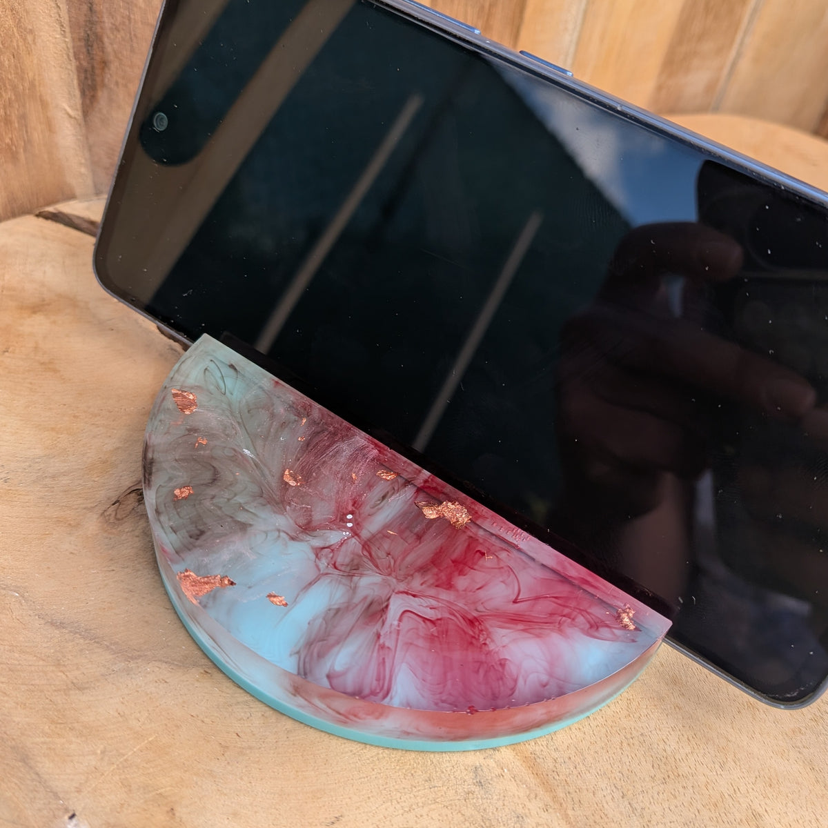 Colourful epoxy resin stand supporting a smartphone upright - EL-Creations