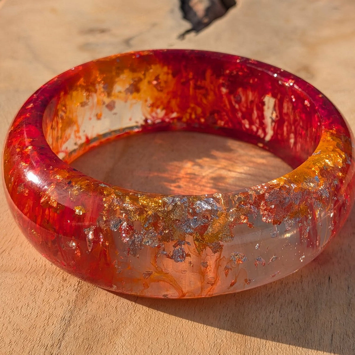 Phoenix fire resin bracelet three quarter angle showing mirror polish and gold leaf – EL-Creations