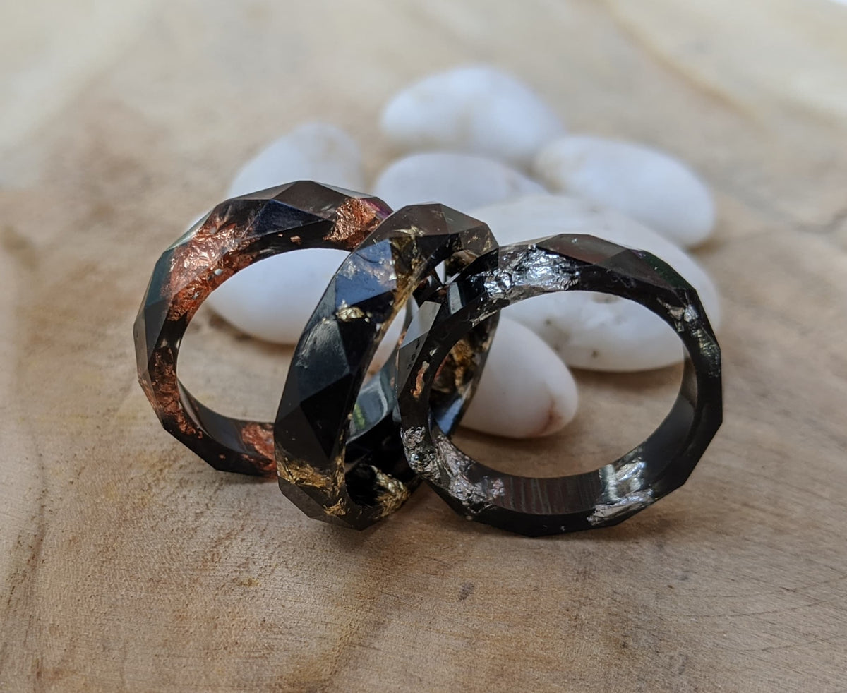 Black faceted unisex ring - artistic angle on wood