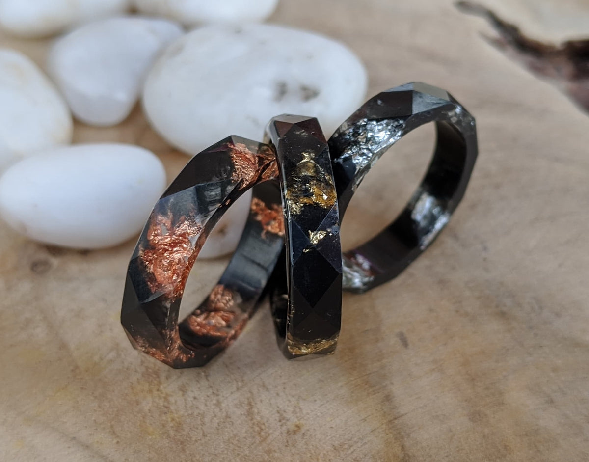 Unisex thin black ring with faceted design - side angle