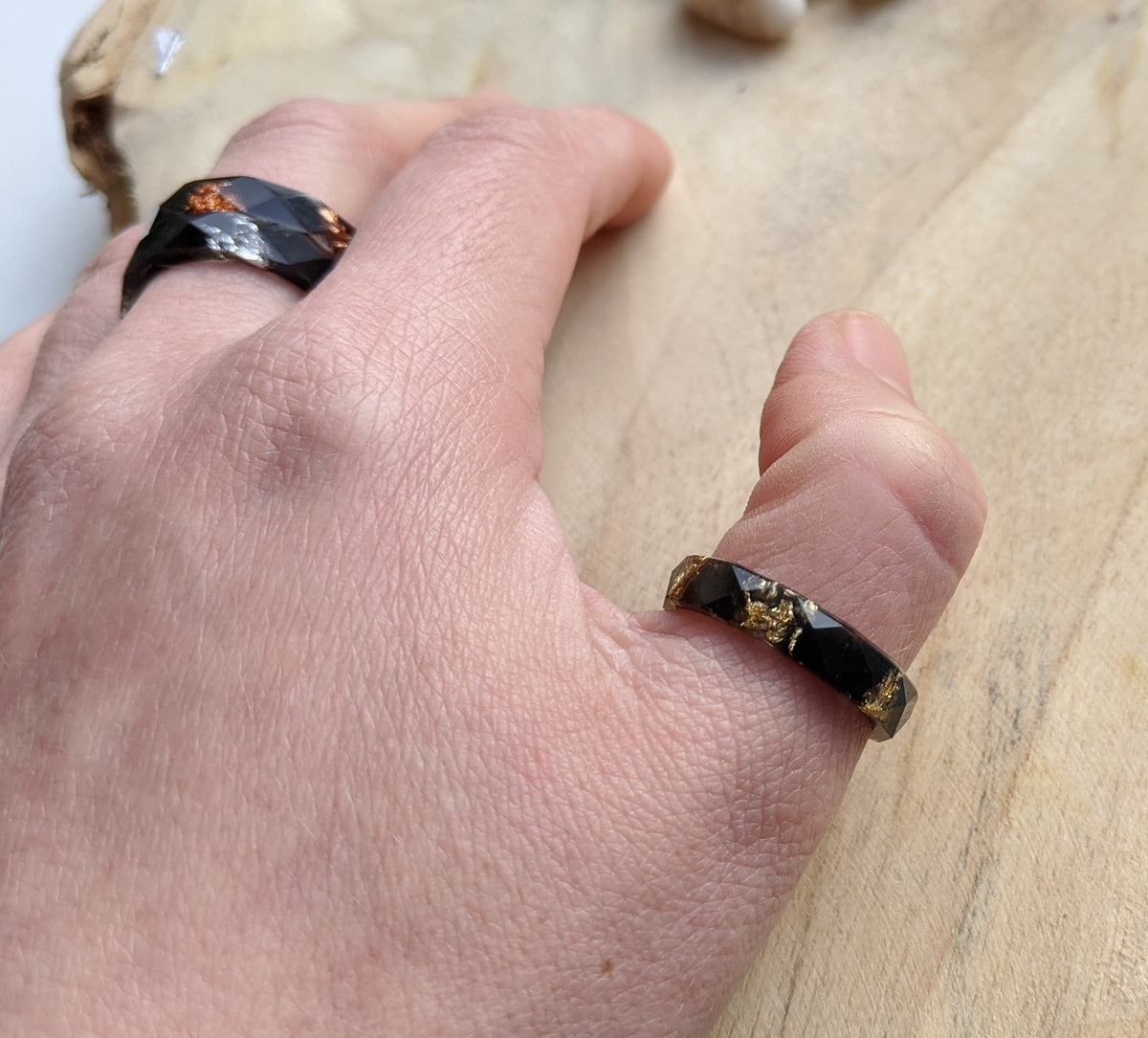 Men's black faceted ring - front view showing geometric cut