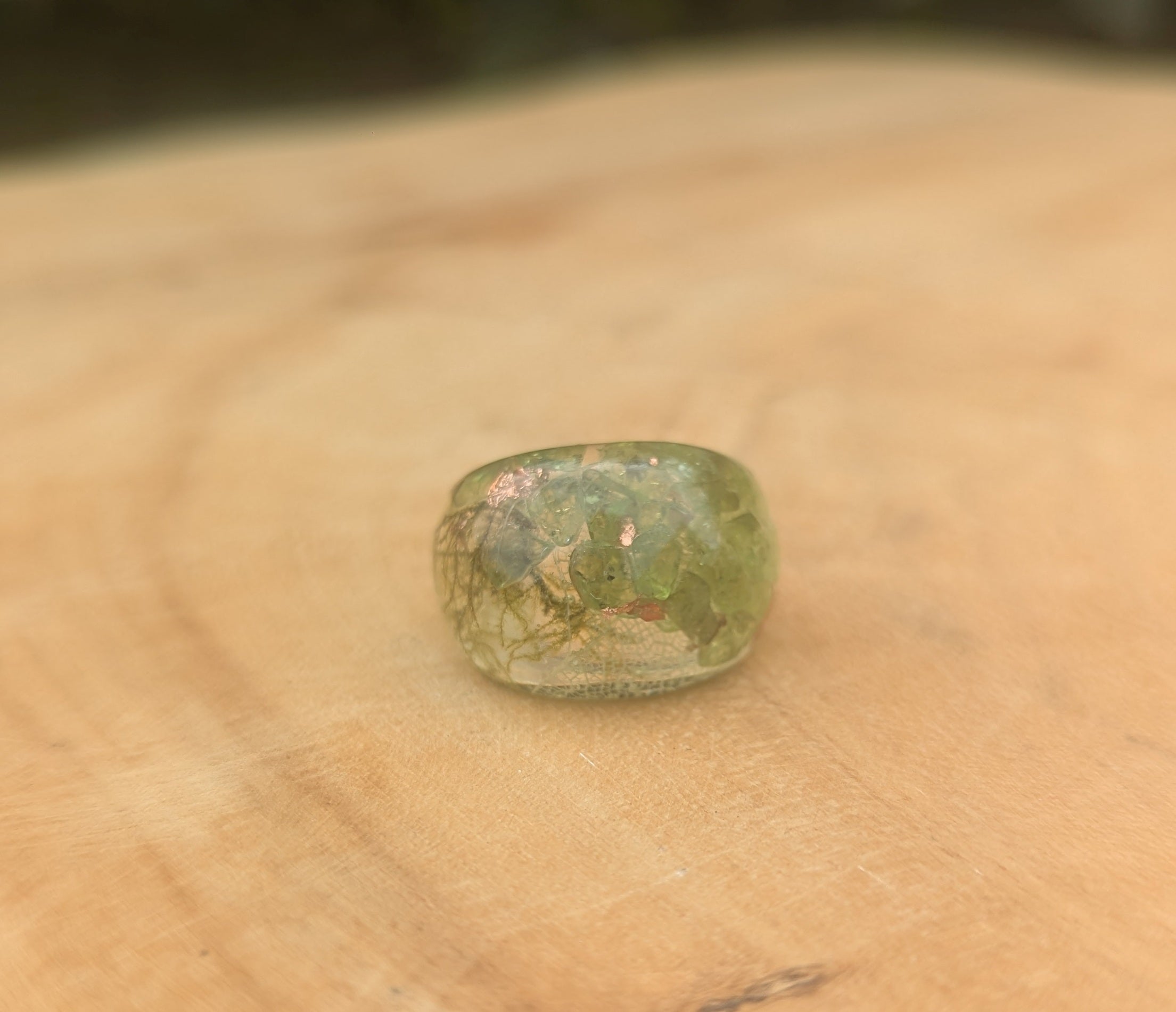 Green gemstone on a beige surface