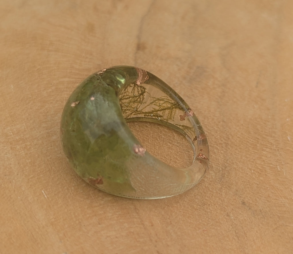 Green glass object on a beige surface