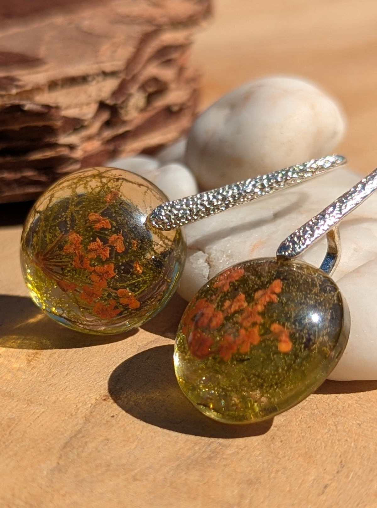 Handmade botanical resin earrings worn on ear, real flower moss jewelry EL Creations Belgium