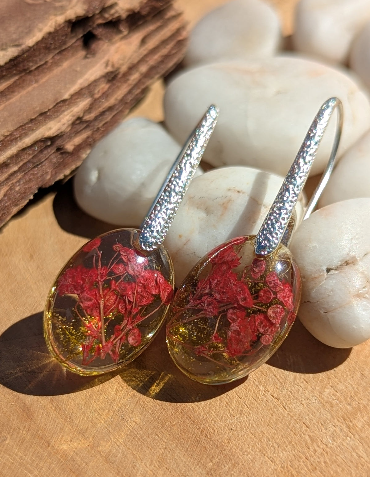 Real red flower and moss oval resin earrings top view, botanical jewelry handmade in Belgium