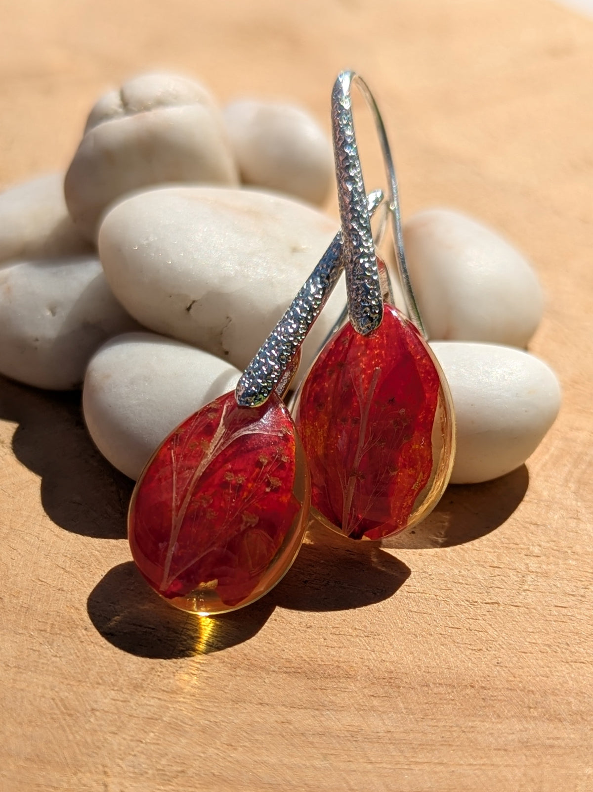 Red flower leaf resin earrings 18x13mm on wooden surface, EL Creations
