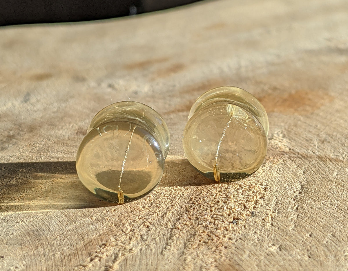 Close up of real dandelion seeds preserved inside clear resin ear plugs EL-Creations
