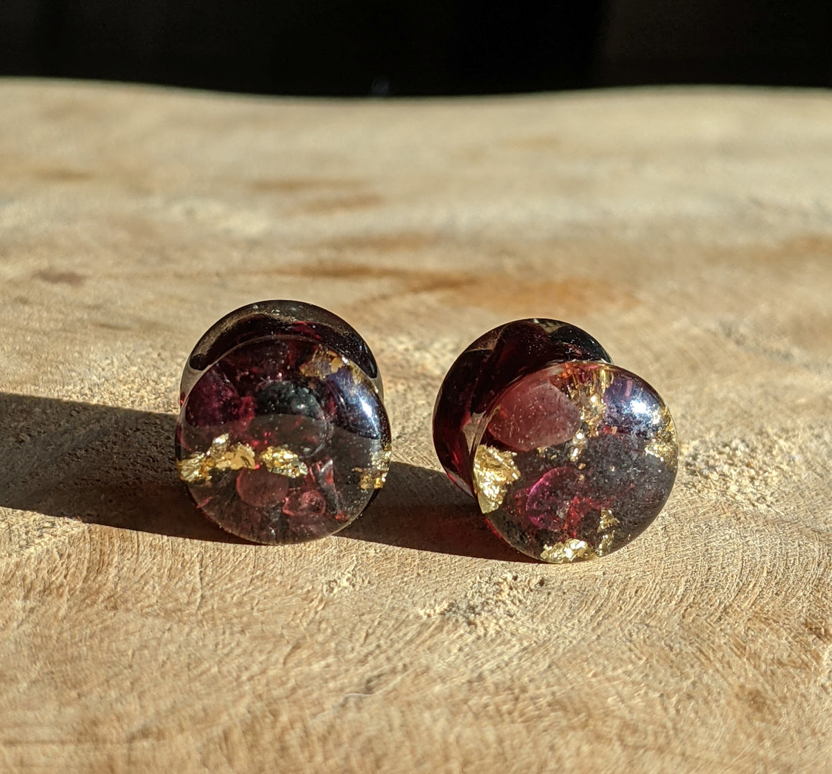 Close up of red garnet stone preserved in resin ear plugs EL-Creations
