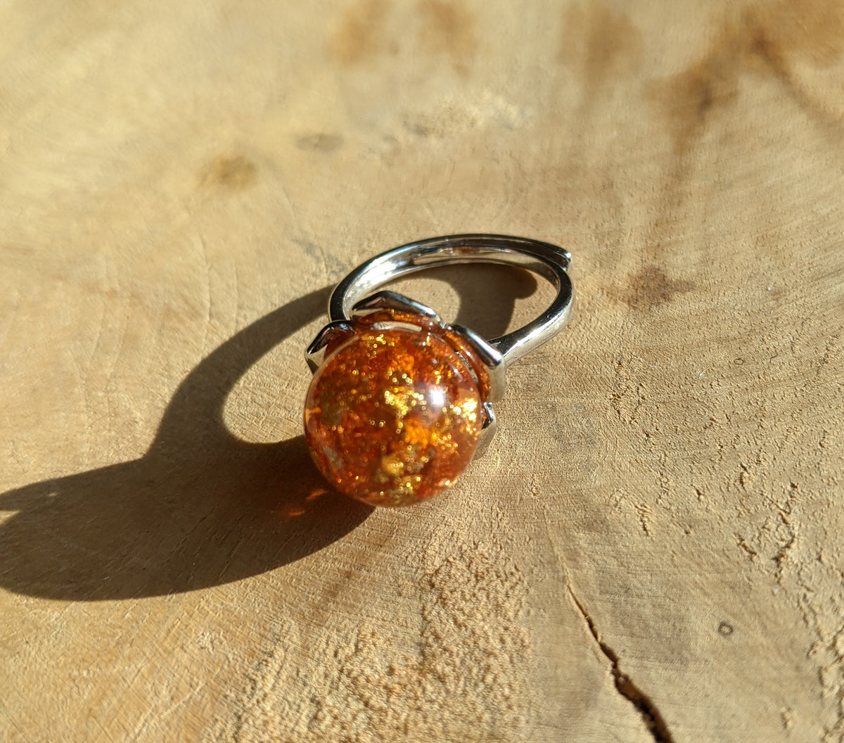 Close-up of amber resin sphere ring – unique handmade jewelry – EL-CreationS