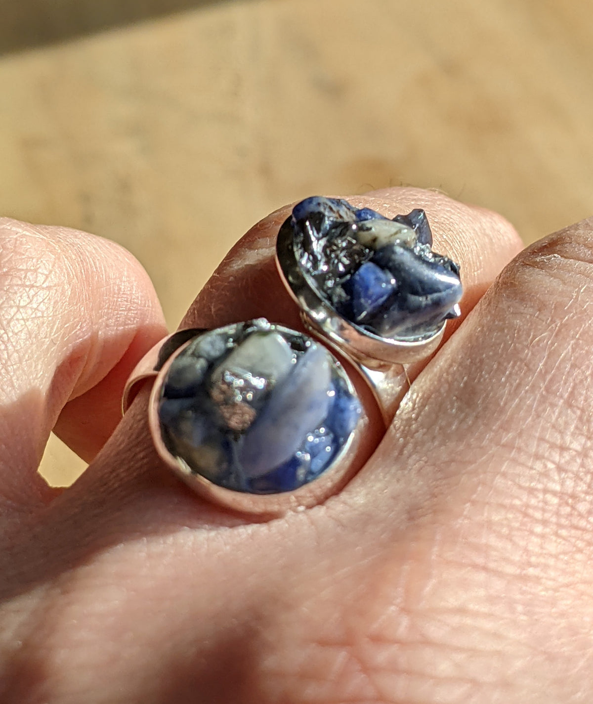 Close-up of sodalite stone and silver flakes inside clear resin ring, EL-Creations