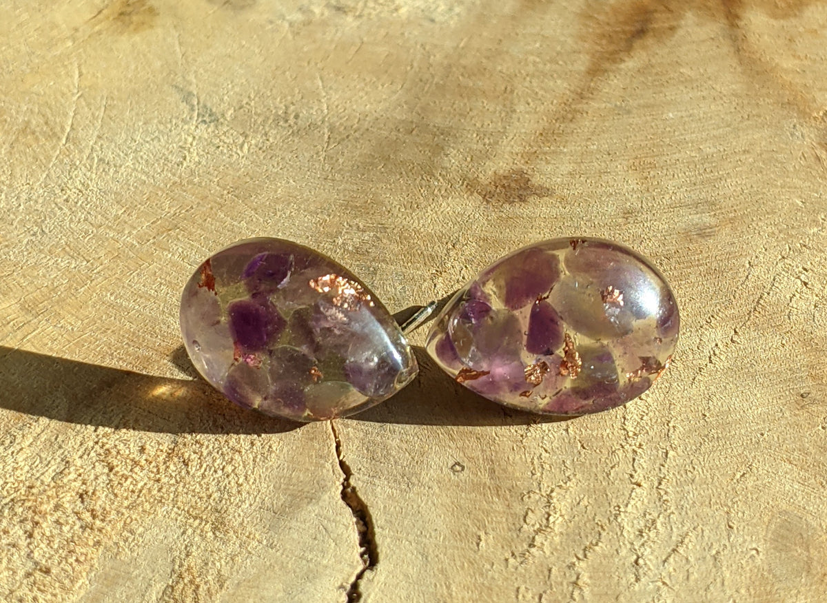 Close-up of natural amethyst and copper flakes inside clear resin stud earrings, EL Creations