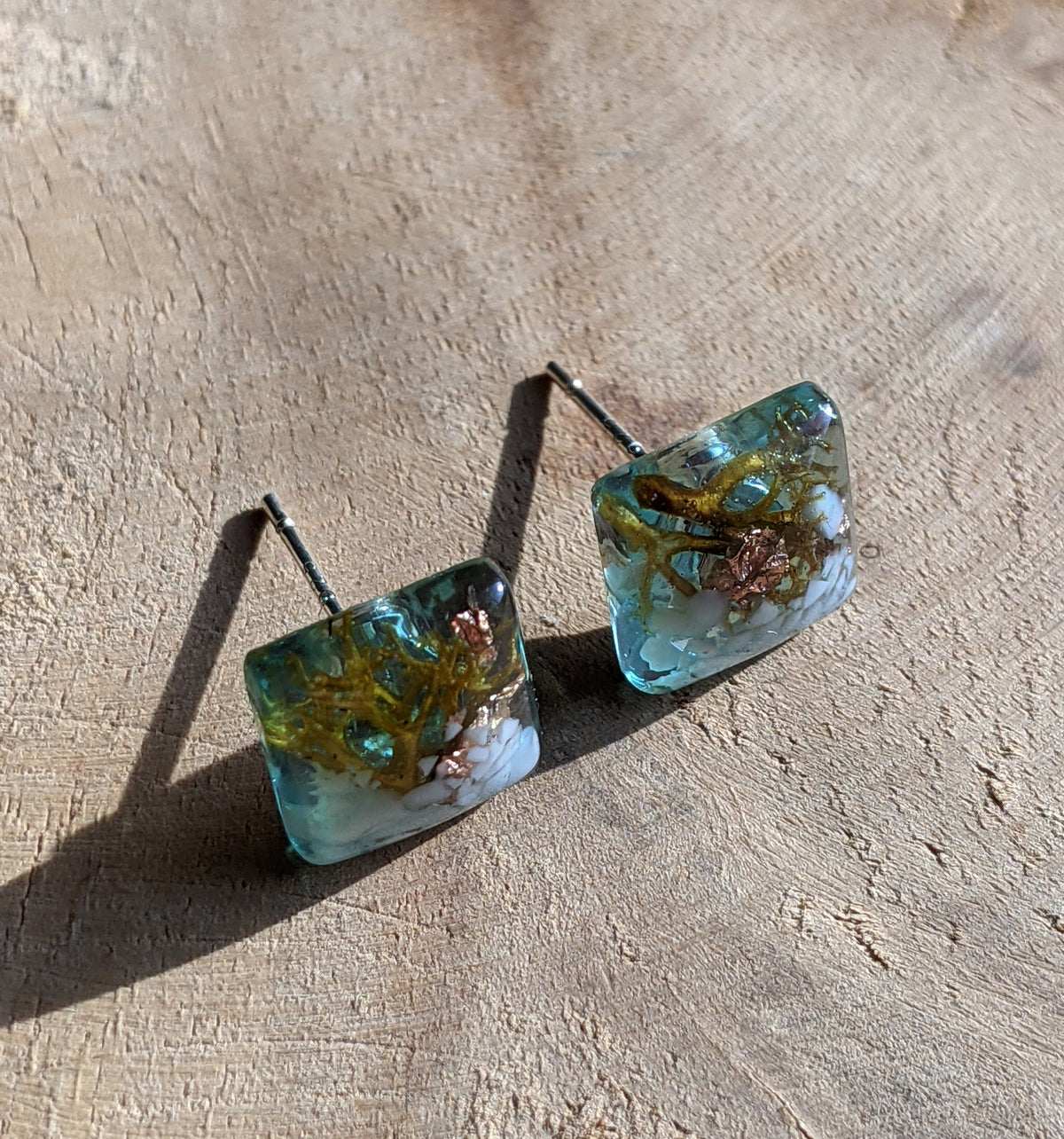Turquoise-tinted white stone moss resin square stud earrings on beige surface, EL Creations