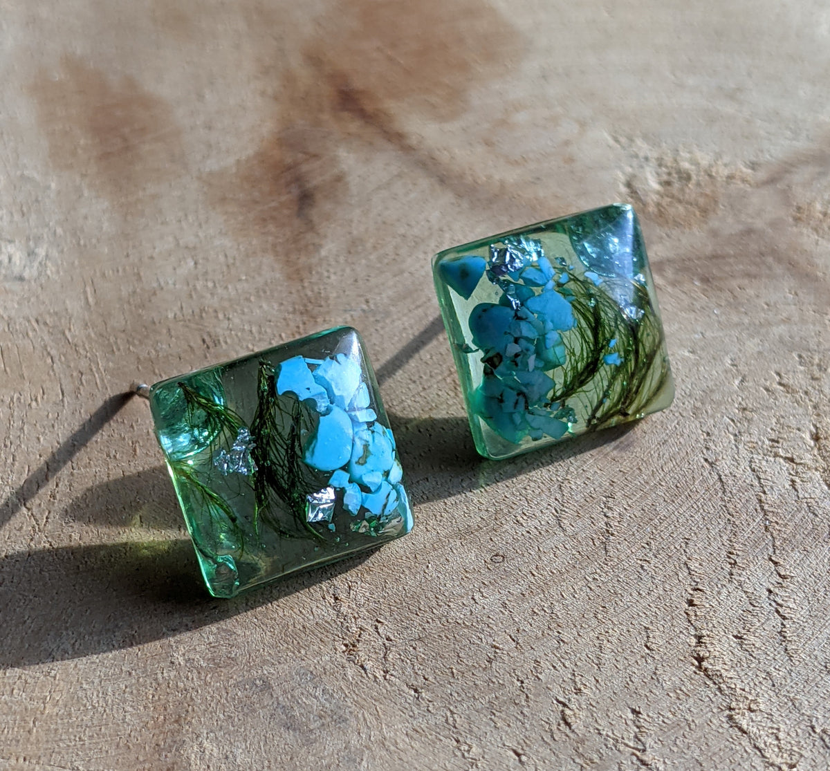 Handmade turquoise stone moss resin square stud earrings worn on ear, coastal jewelry EL Creations Belgium
