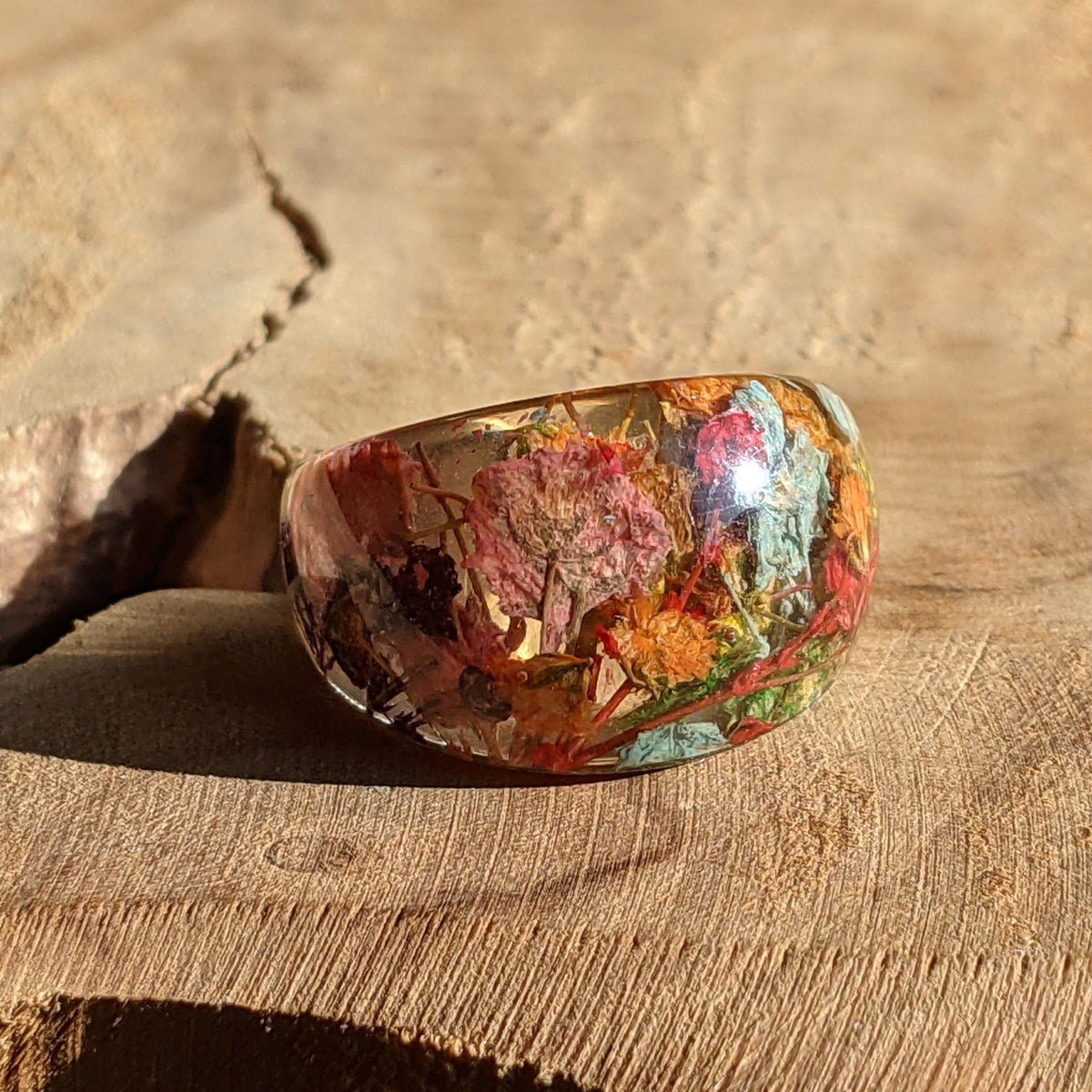 Botanical rainbow resin ring featuring preserved multicolor flowers by EL-Creations