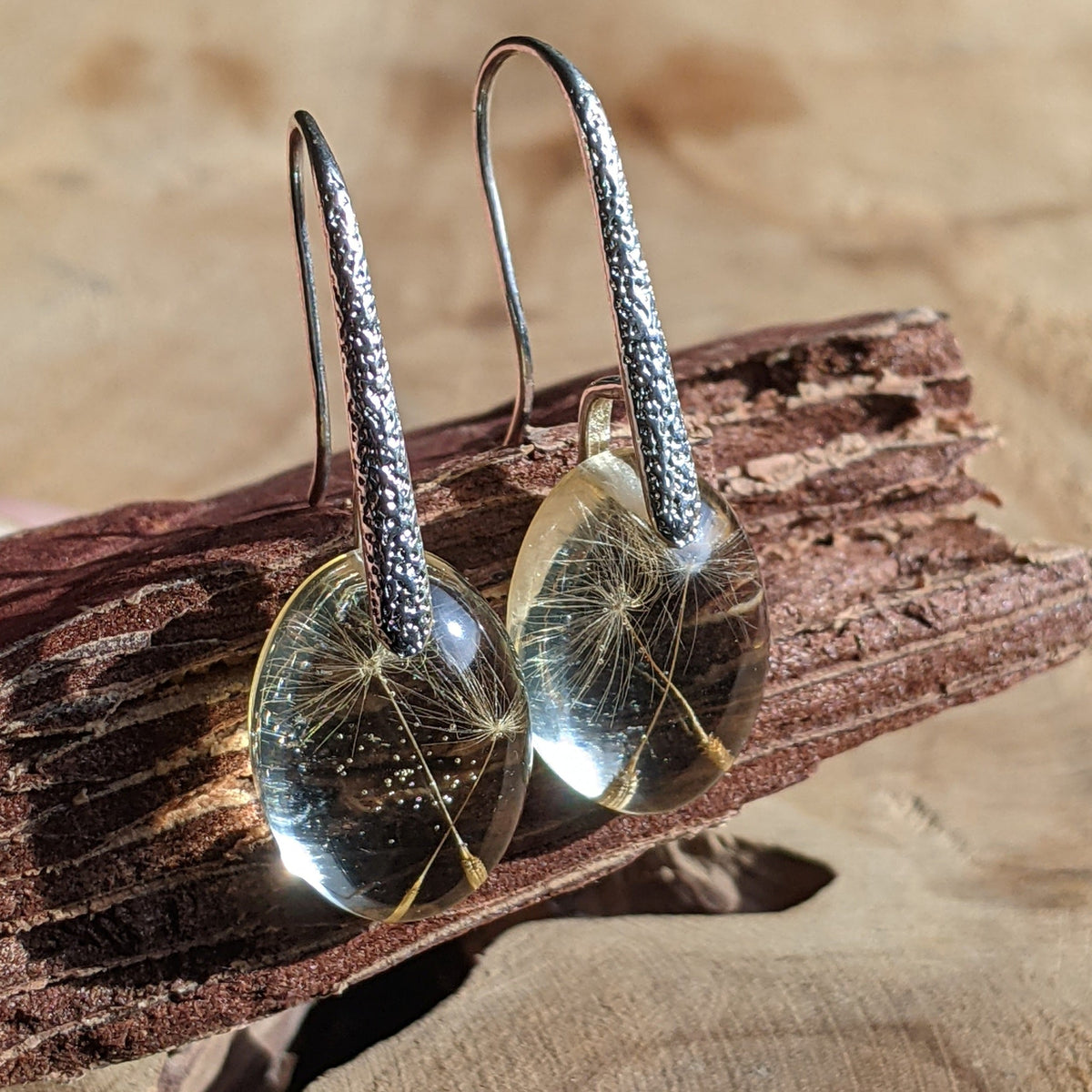 Handmade real dandelion seed resin oval earrings on wooden surface, EL Creations Belgium