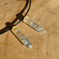 Crystal pendant necklace on a wooden surface