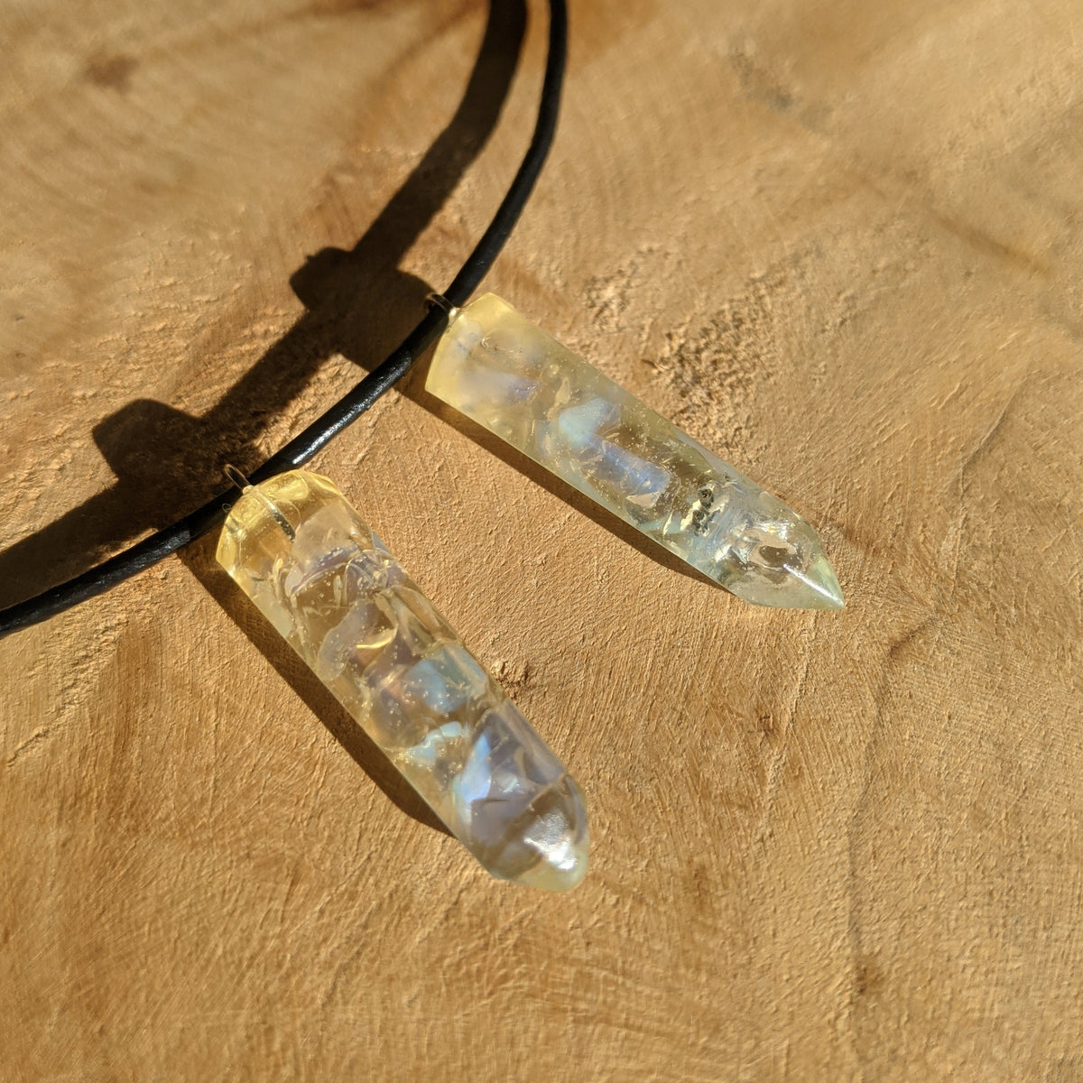 Crystal pendant necklace on a wooden surface
