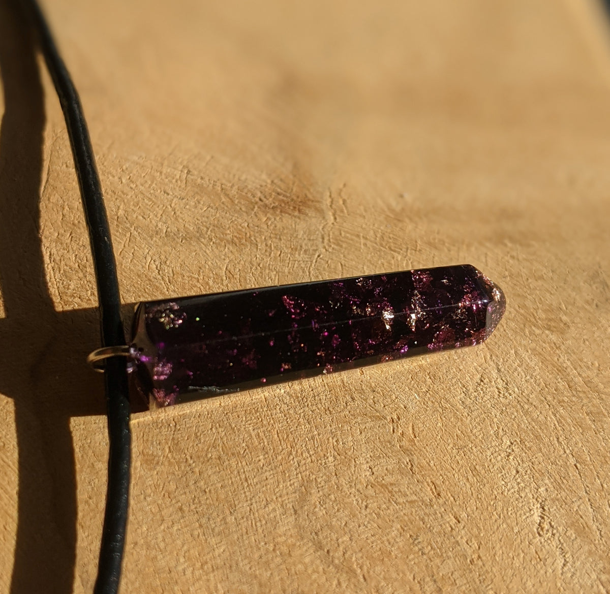 Close up view of gold and copper flakes inside purple resin pendant necklace EL-Creations