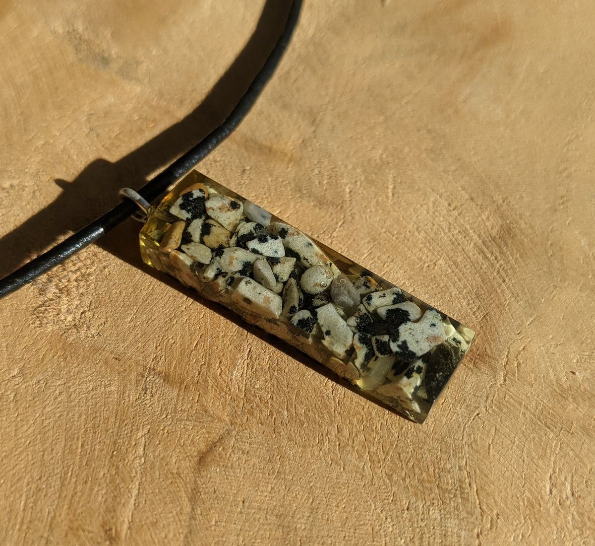Handmade resin pendant necklace featuring Dalmatian stone details and black leather cord EL-Creations