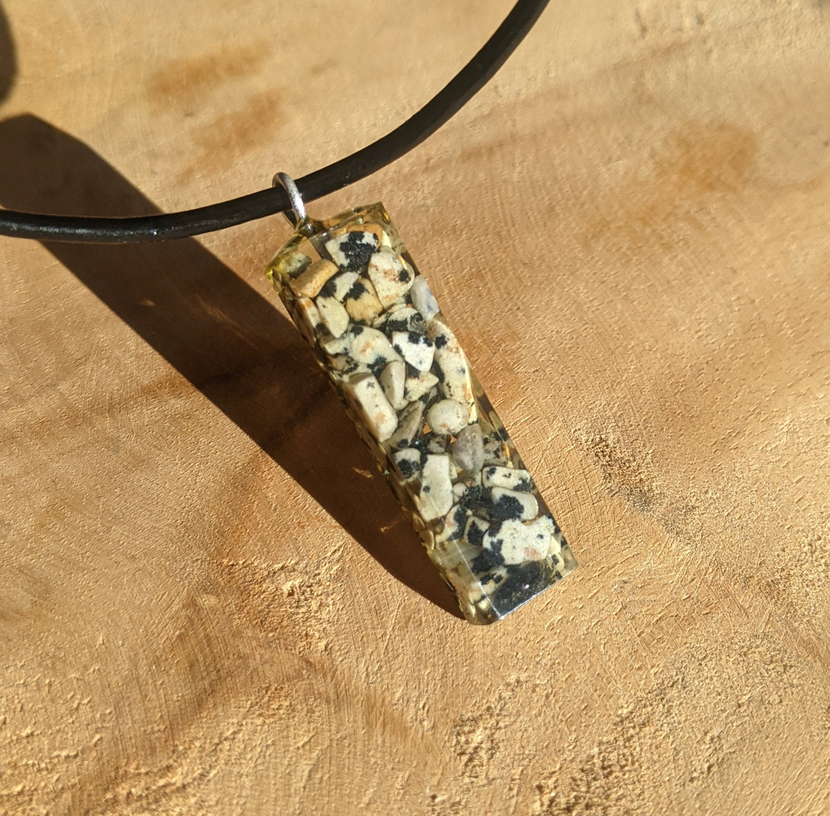 Close up view of natural stone embedded in clear resin rectangle pendant EL-Creations