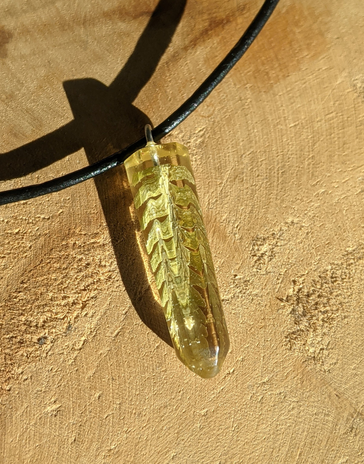 Close up botanical jewelry necklace featuring real fern leaves inside resin EL-Creations