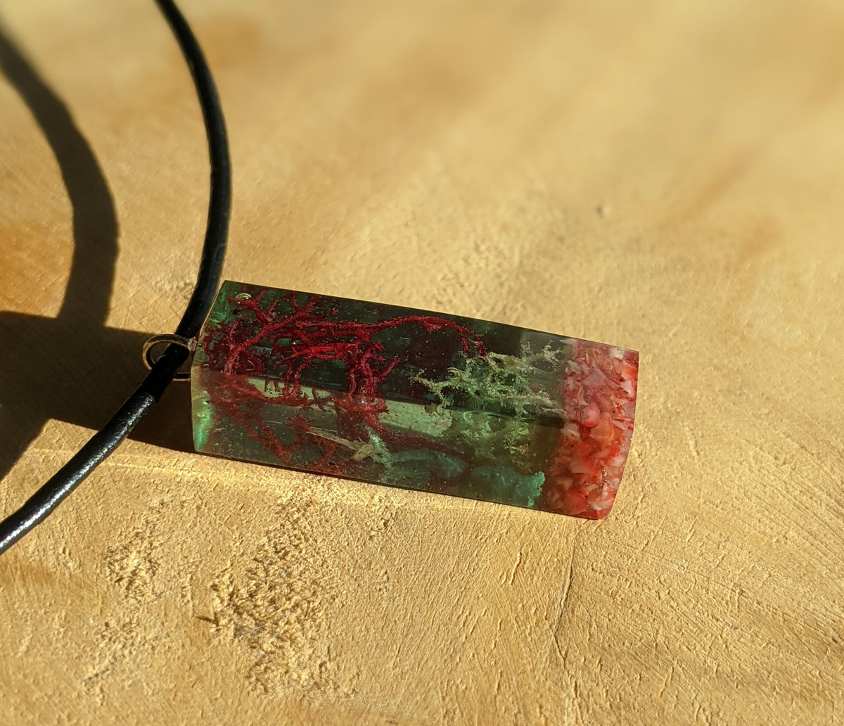 Handmade resin necklace with red coral and green moss crafted in Belgium EL-Creations