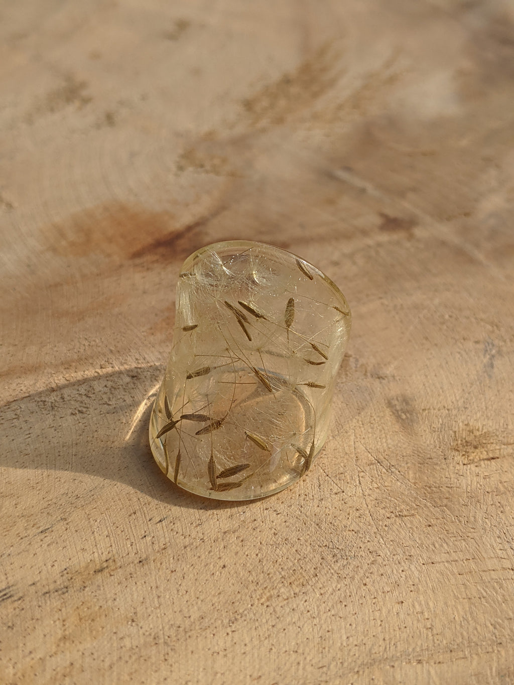 Clear stone with engraved design on a beige surface