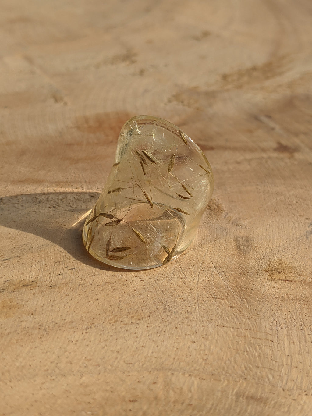 Clear glass sandal on a textured beige surface
