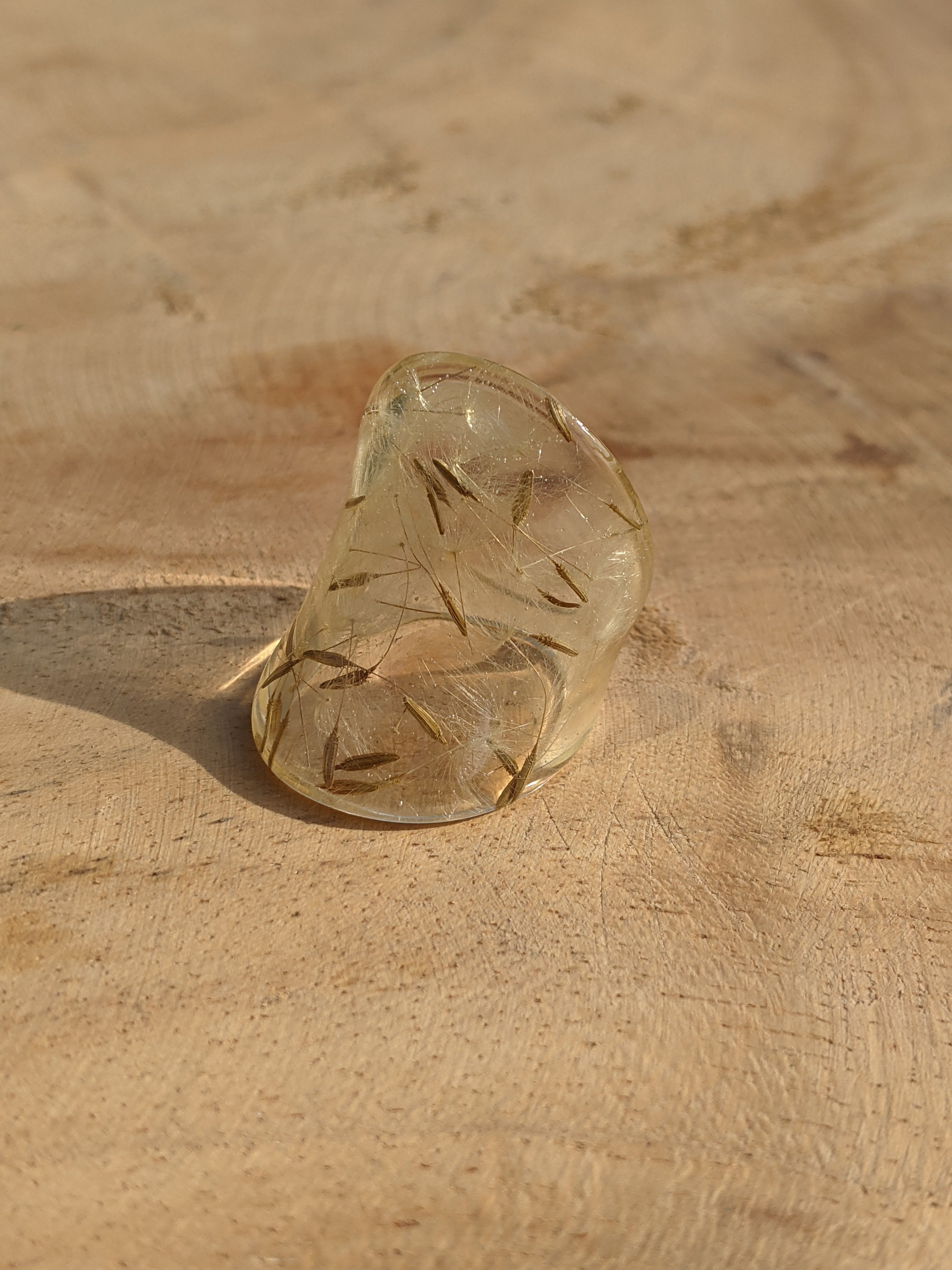 Clear glass sandal on a textured beige surface