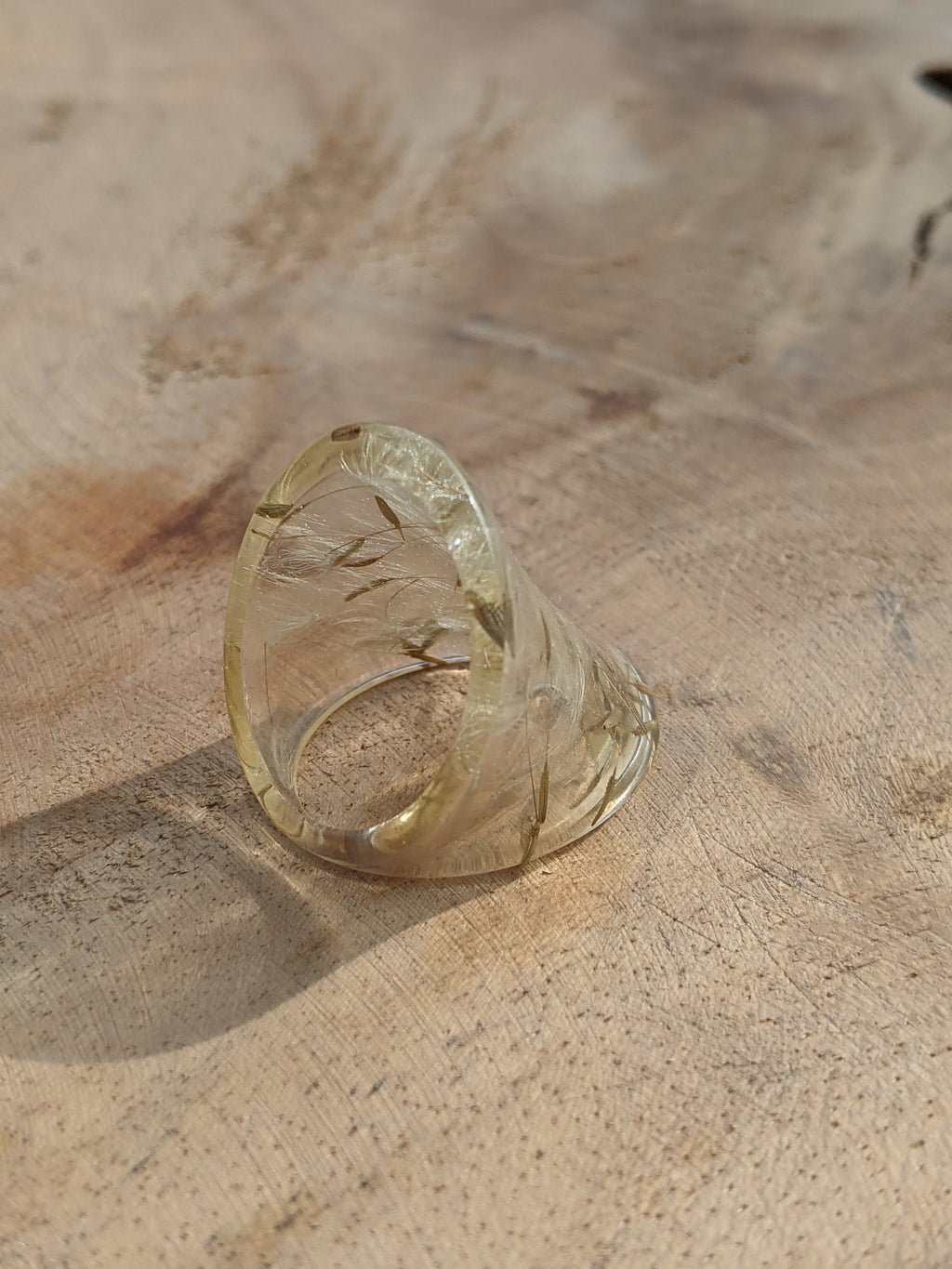 Clear glass ring on a textured beige surface