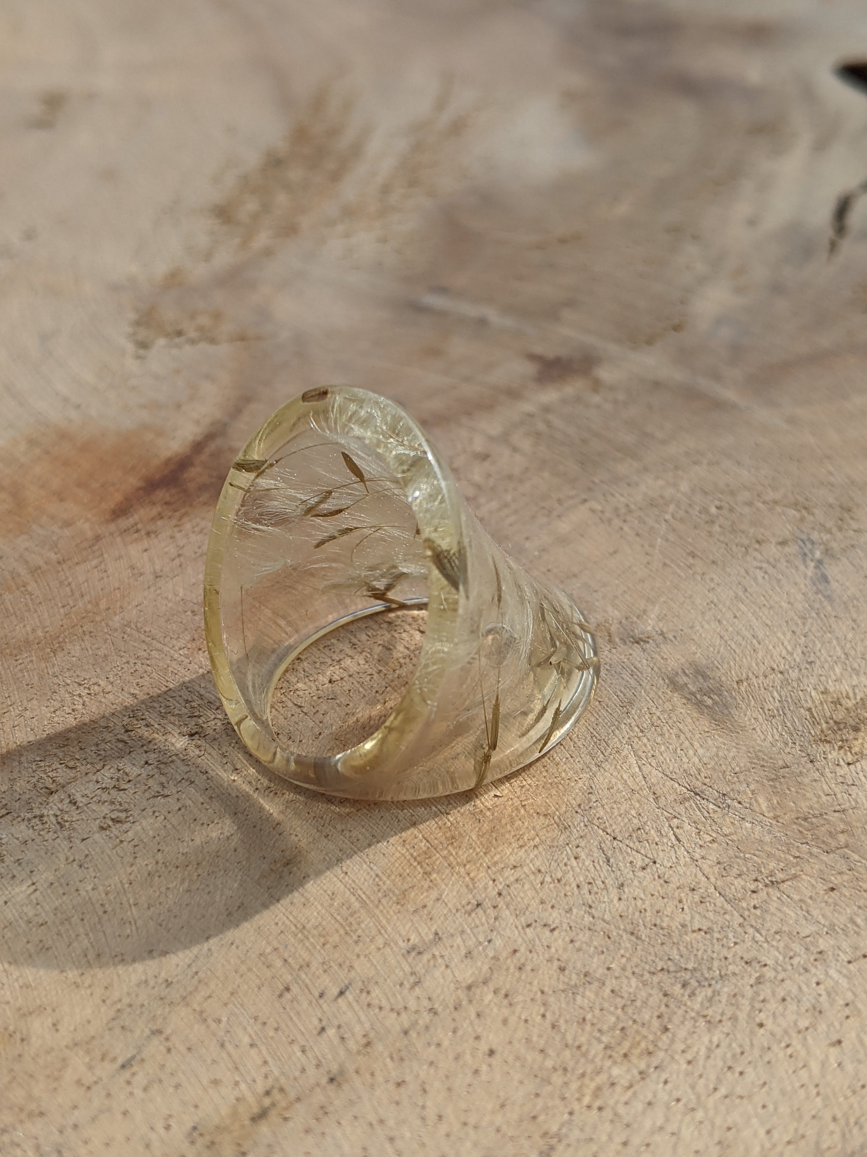 Clear glass ring on a textured beige surface
