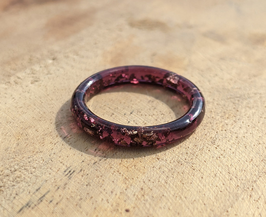 Purple ring on a textured beige surface