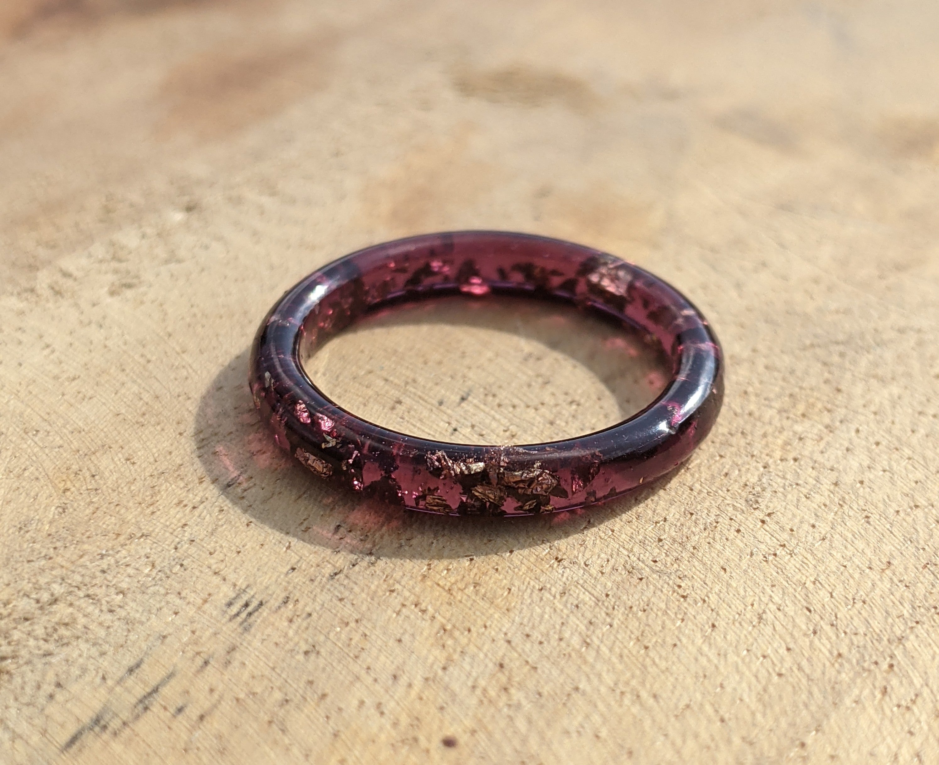 Purple ring on a textured beige surface
