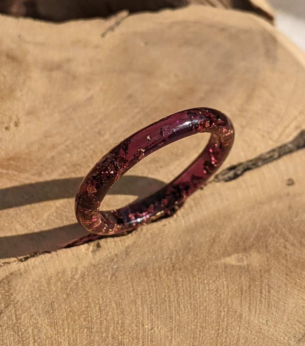 Red glittery ring on a textured beige surface