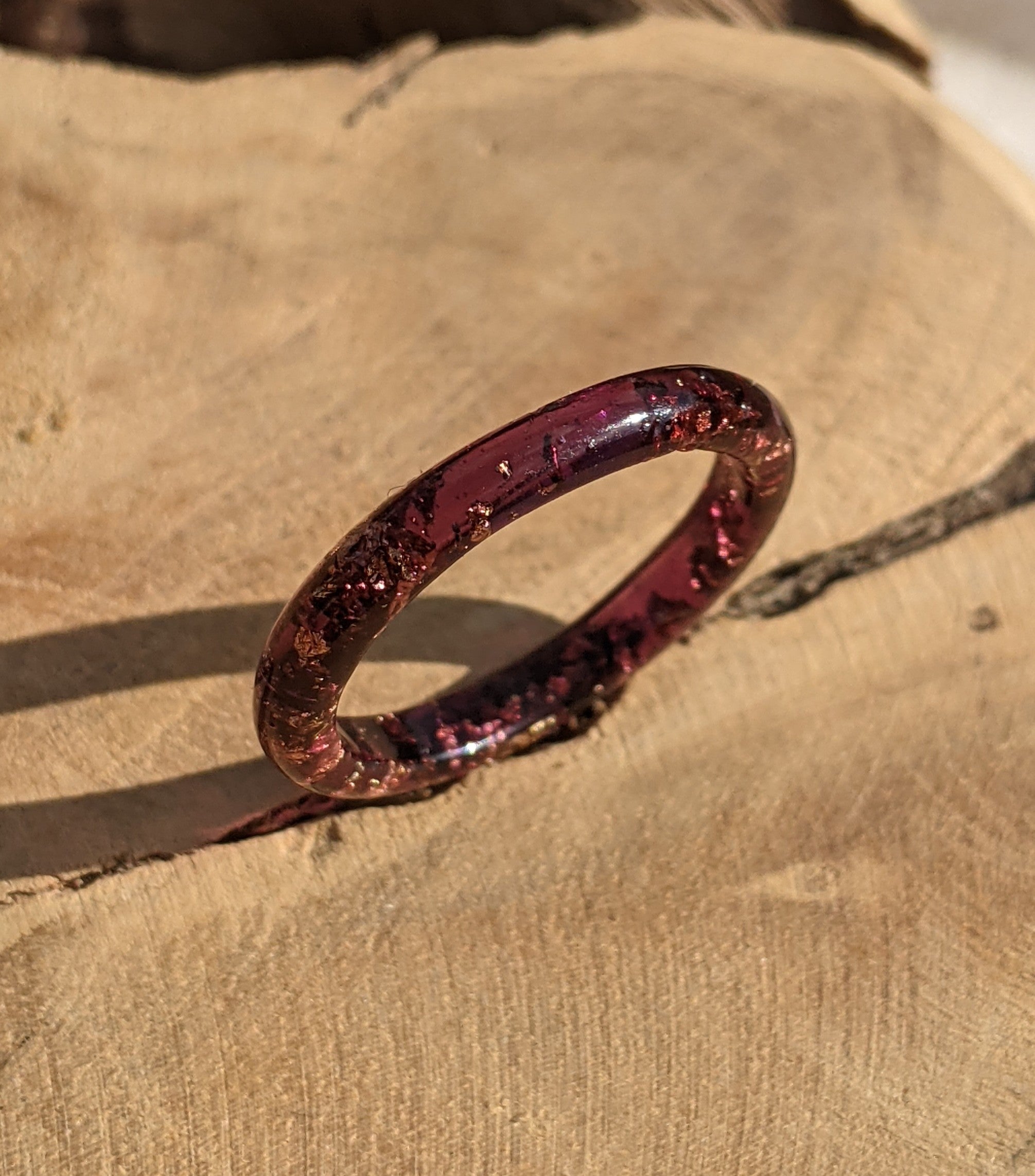 Red glittery ring on a textured beige surface
