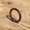 Reddish-brown ring on a wooden surface