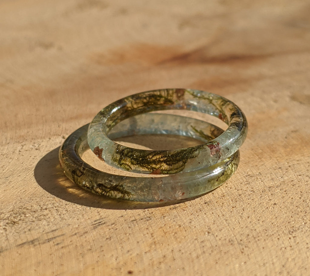 Two glass rings on a wooden surface
