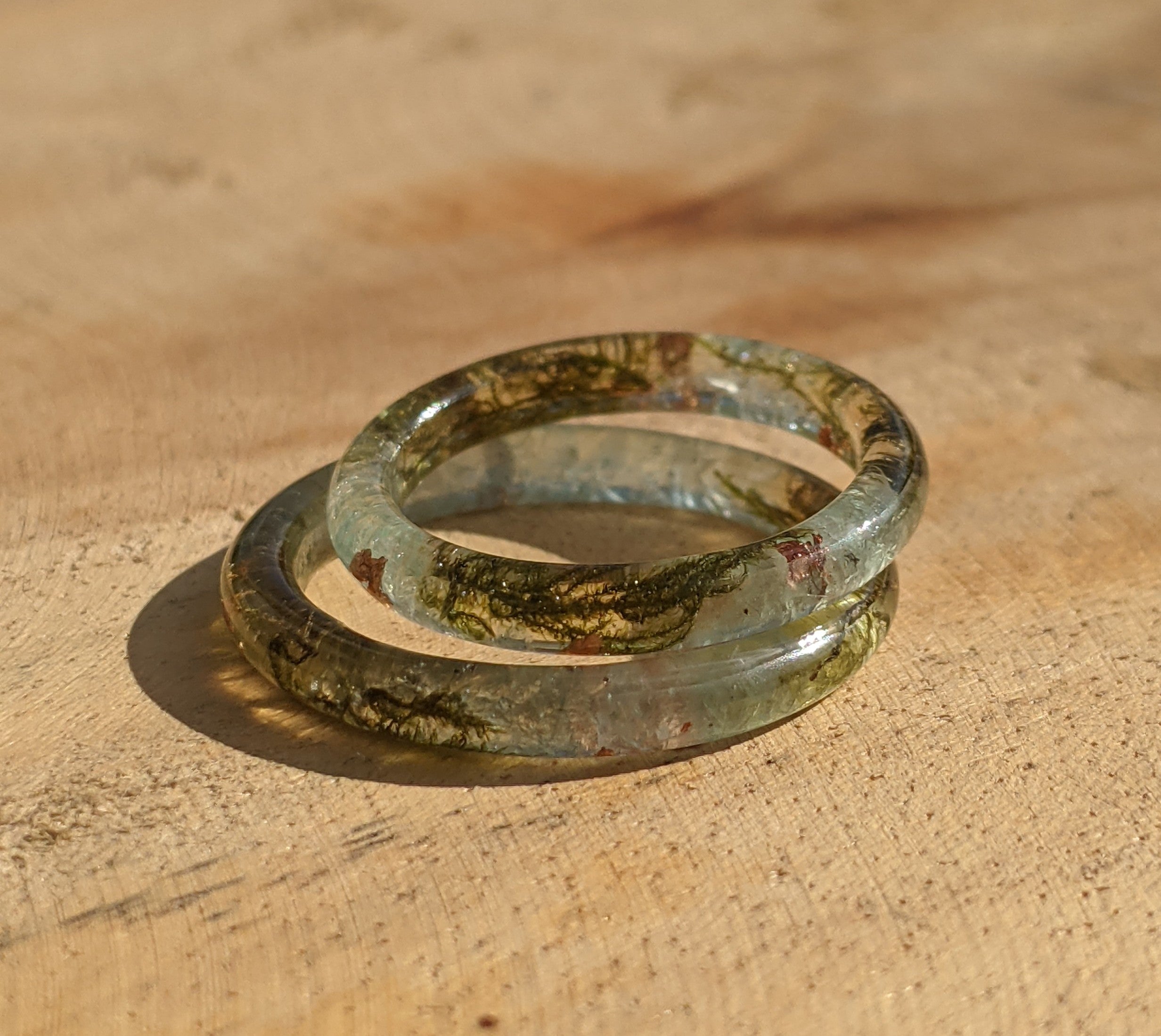 Two glass rings on a wooden surface
