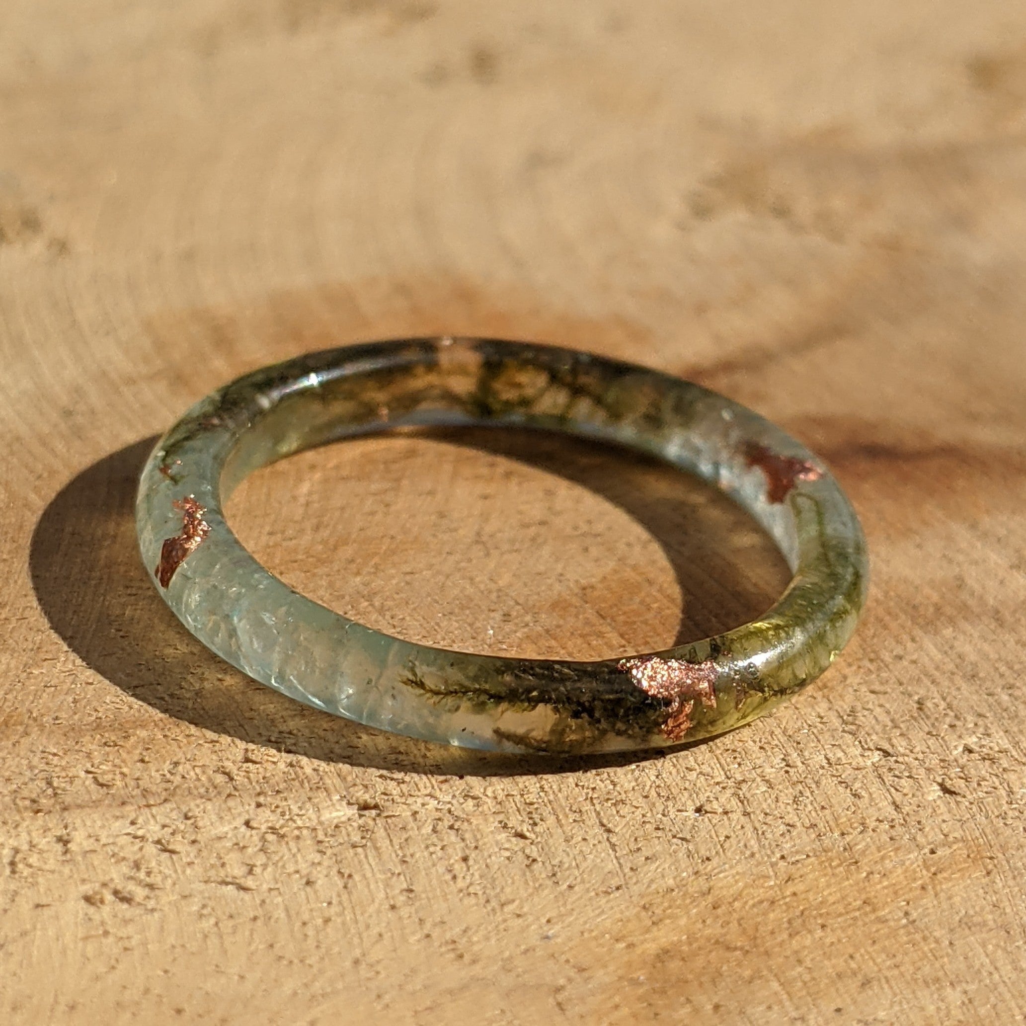 Ancient glass ring on a wooden surface