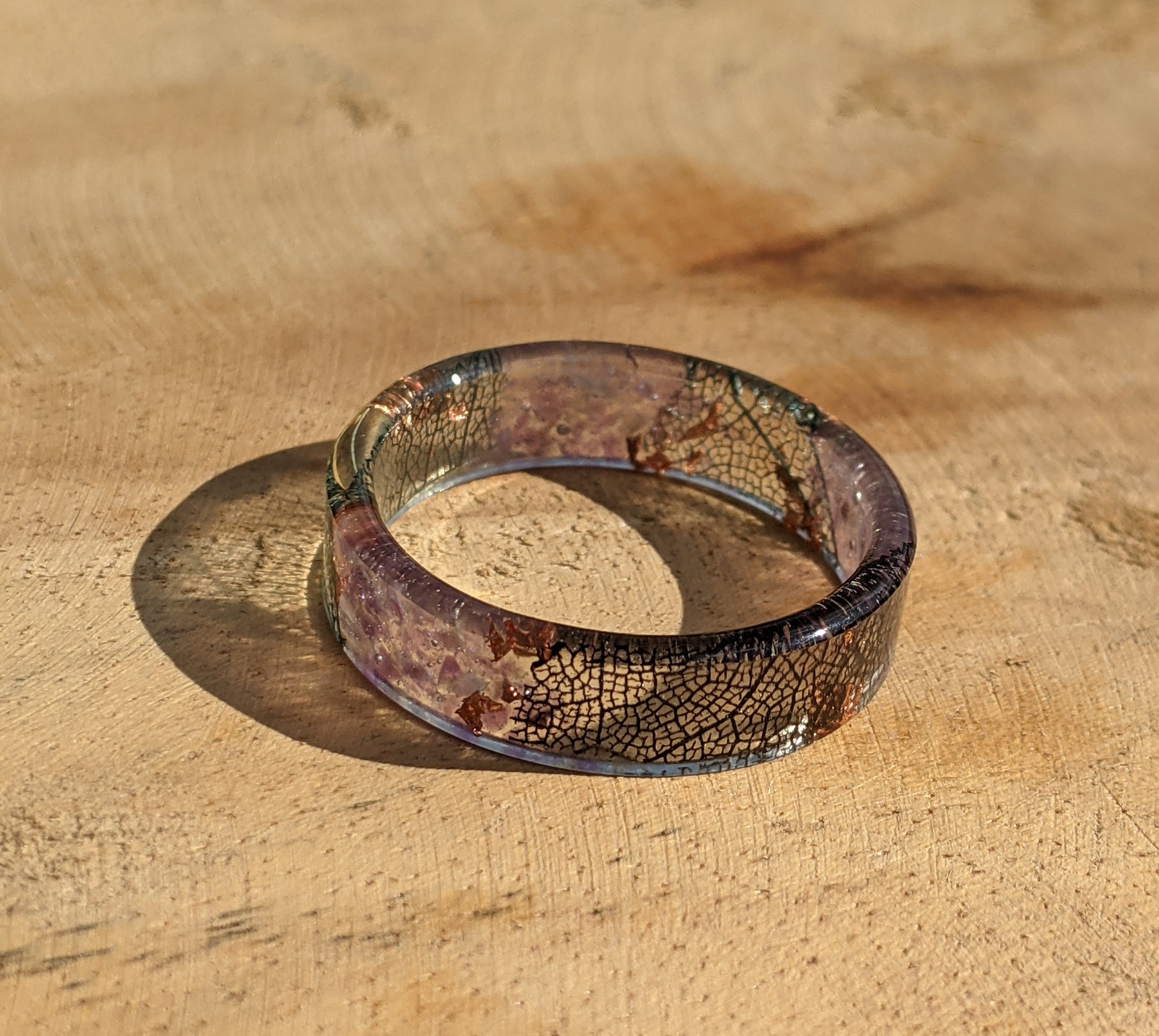 Resin ring with a cracked design on a wooden surface