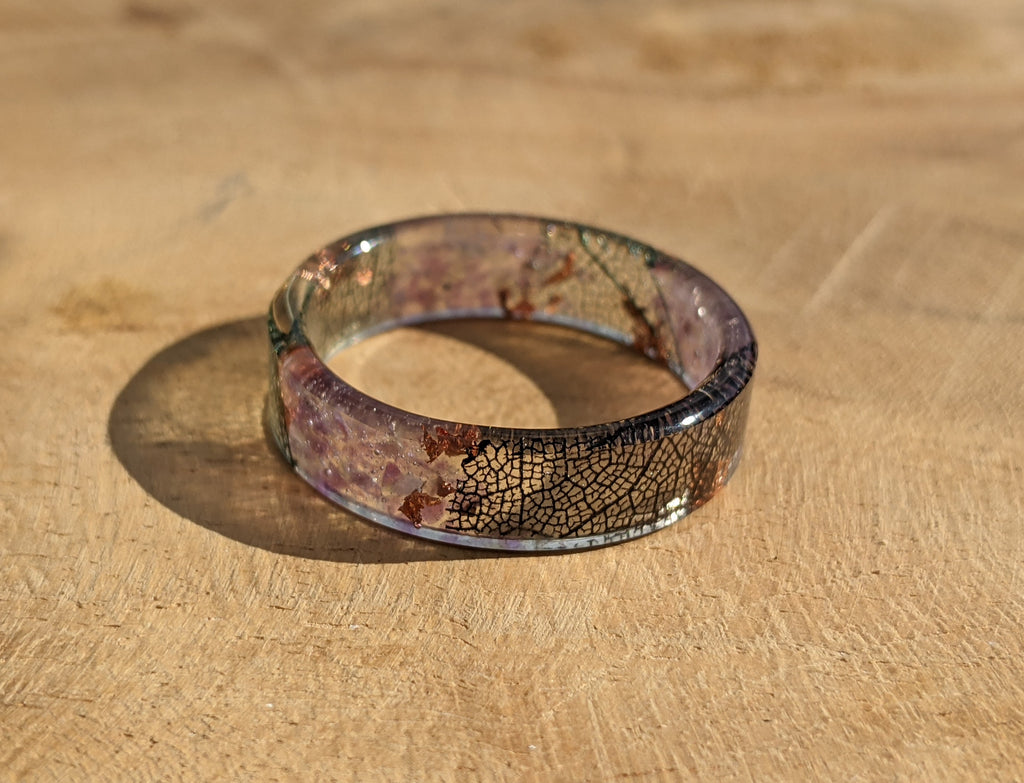 Resin ring with a cracked glass design on a wooden surface