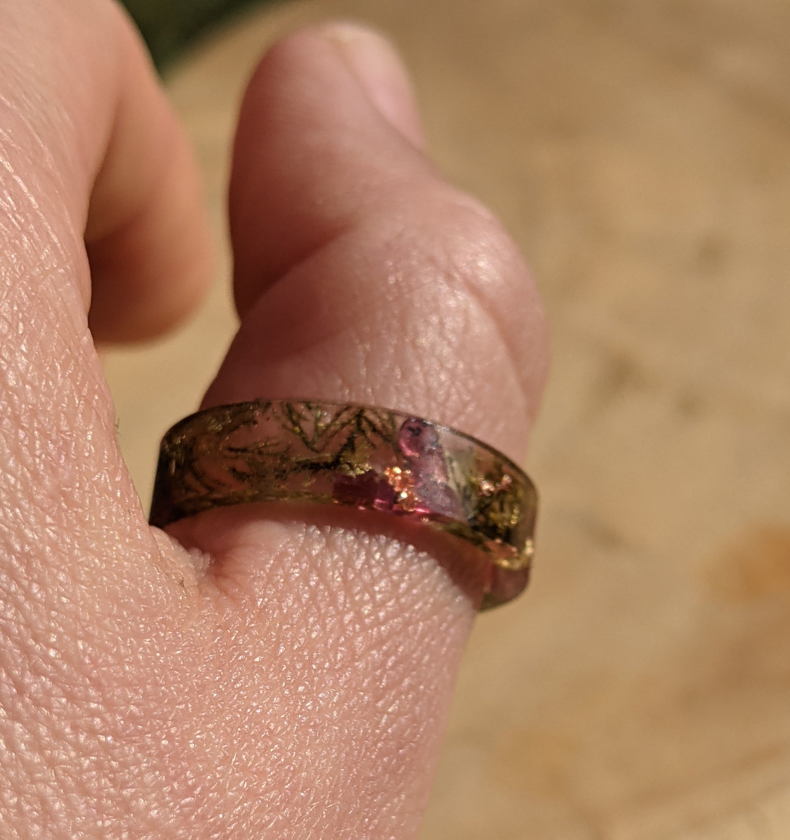 Decorative ring on a finger with a blurred background