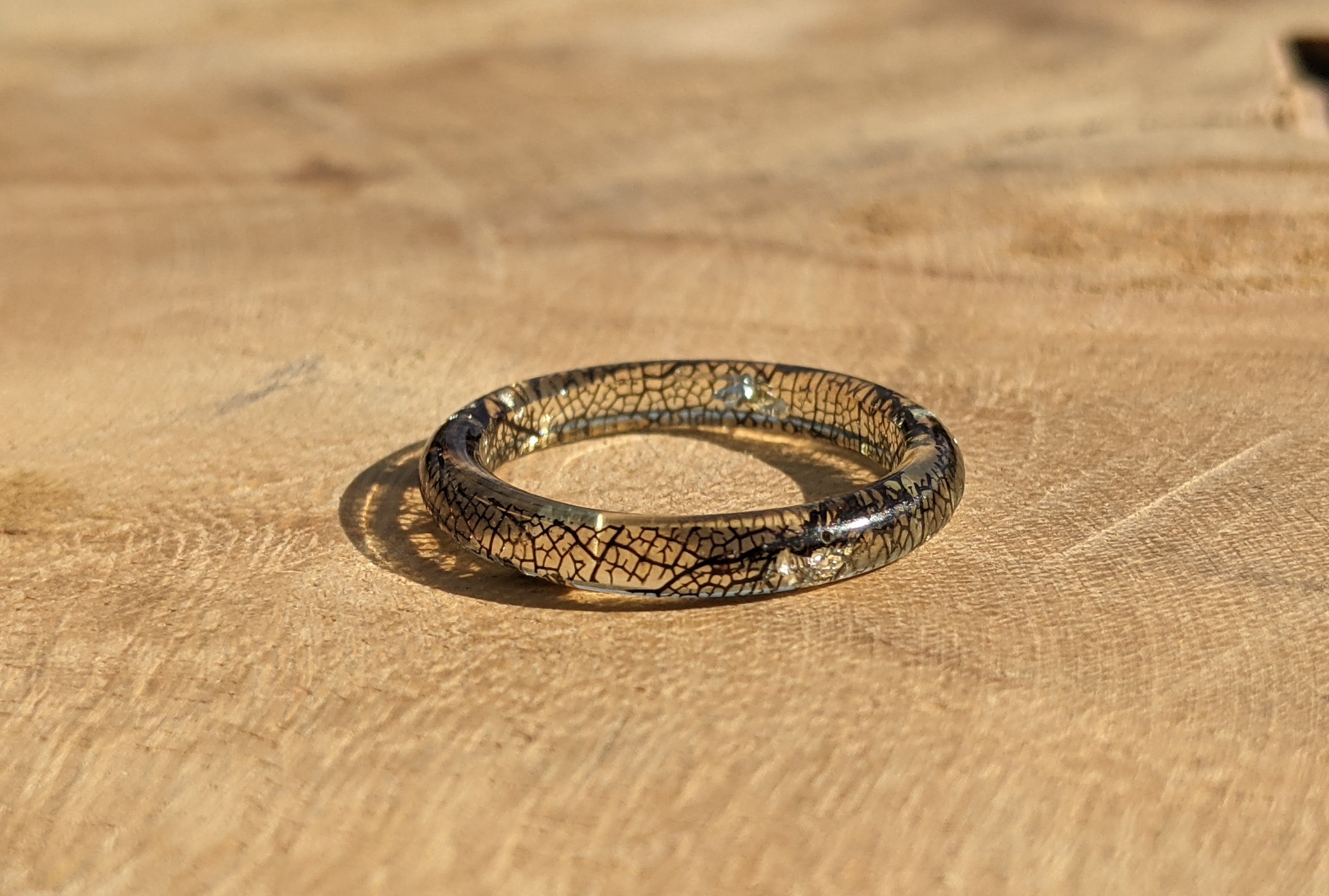 Thin resin ring on a wooden surface
