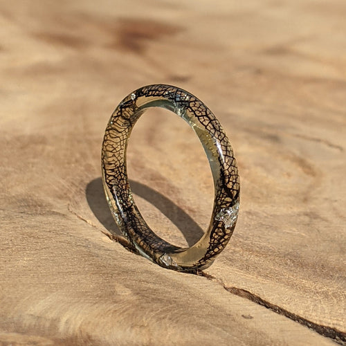Ring with a unique design on a wooden surface