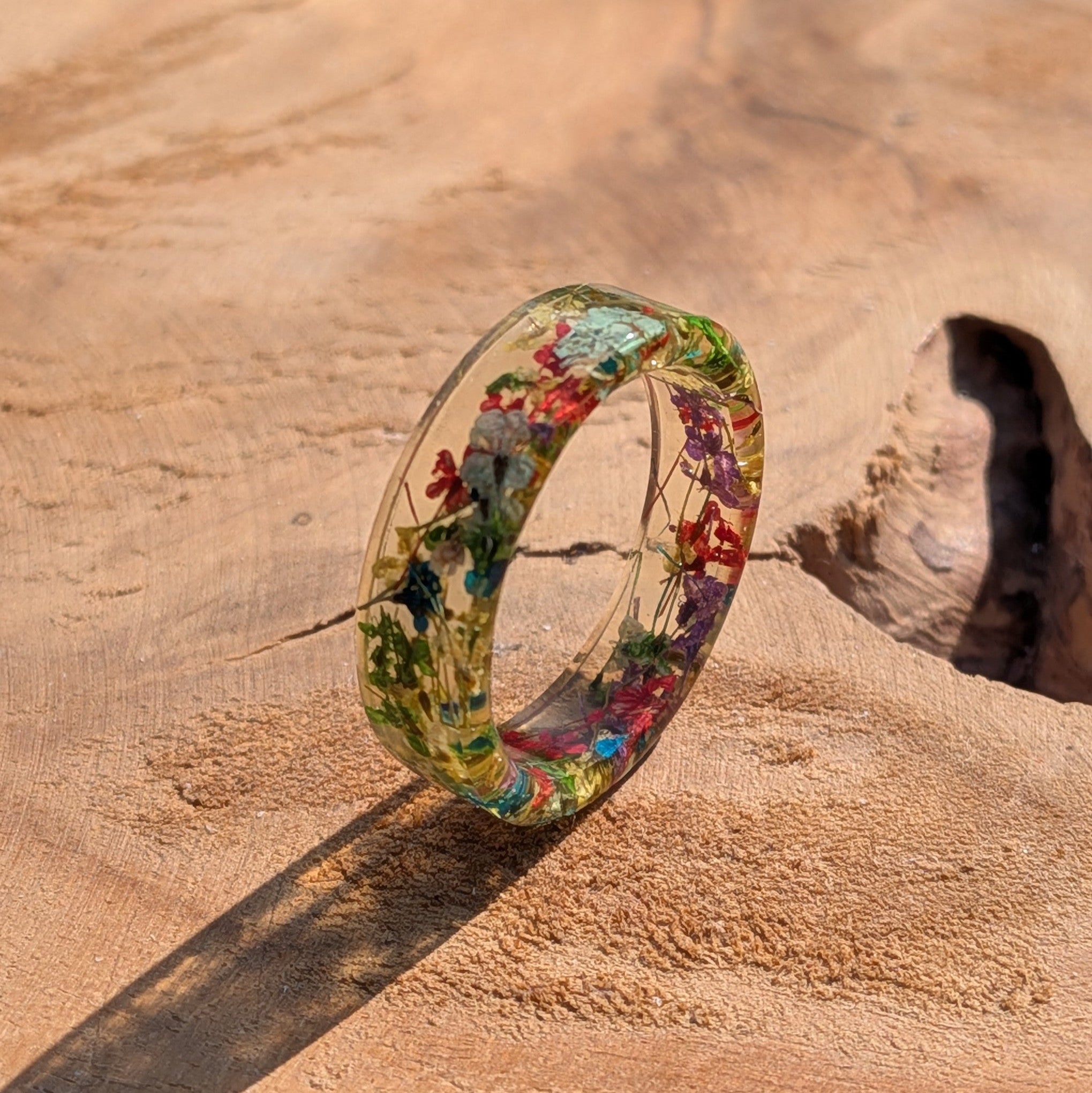 Colorful floral ring on a wooden surface
