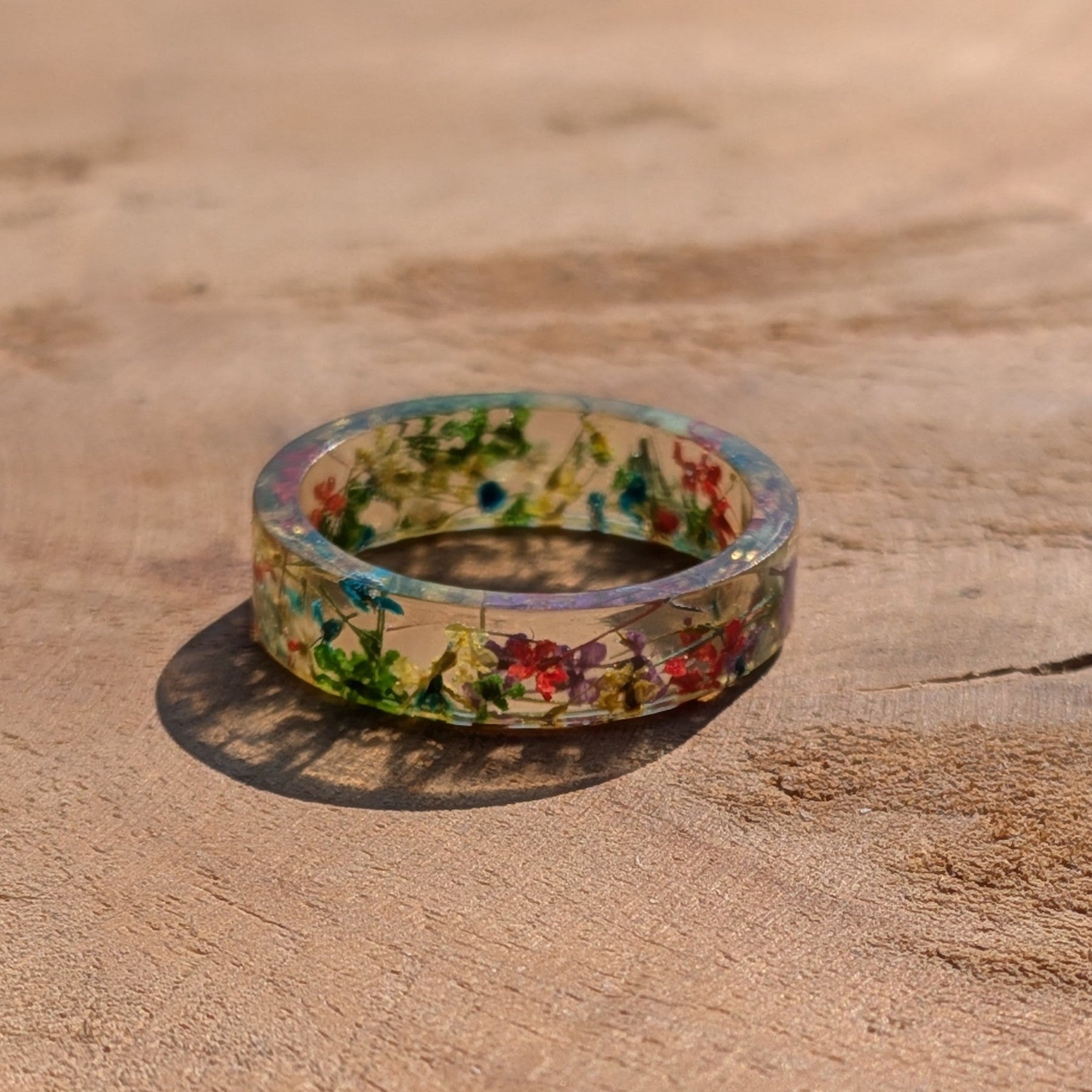Floral-patterned ring on a wooden surface
