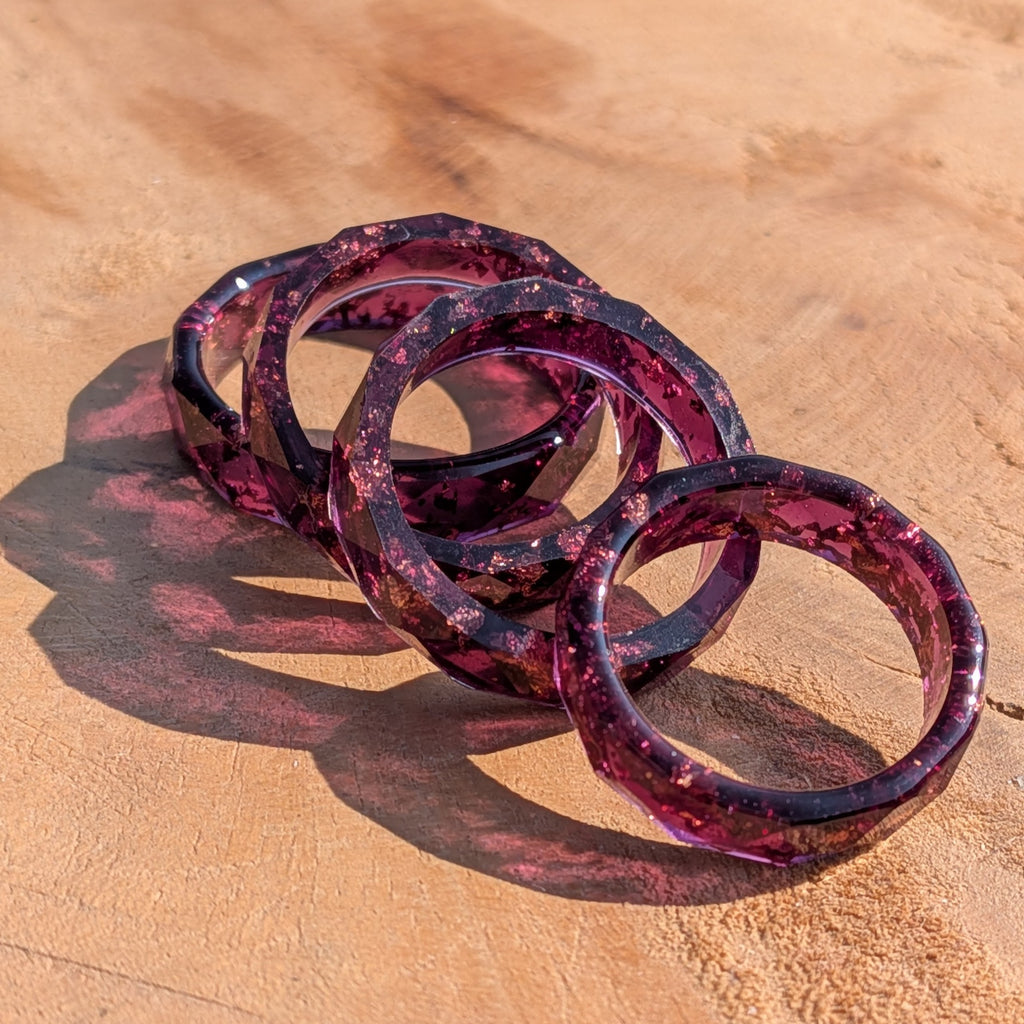 Set of red purple rings on a wooden surface